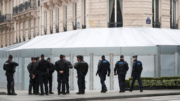 French gendarmes and riot police officers secure the Champs-Elysees avenue in front of the famed restaurant Fouquet's during the Act XIX (the 19th consecutive national protest on a Saturday) of the "yellow vests" movement in Paris